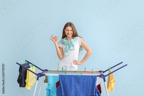 Woman hanging clean clothes...