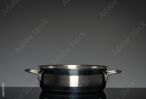 New cookware on black background, front view © fotofabrika