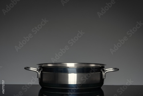 New cookware on black background, front view