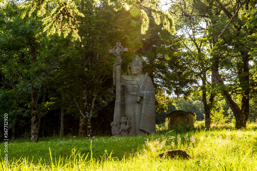 old stone statue in the forest