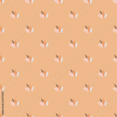 Mini leaves seamless pattern on pastel light coral background. Spring floral wallpaper.