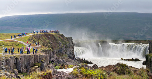 Many tourists looking at Godafoss waterfall in northern Iceland, low view