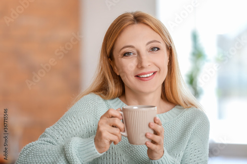 Beautiful woman drinking te...