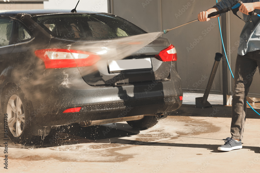 Fototapeta premium Man washing his car outdoors