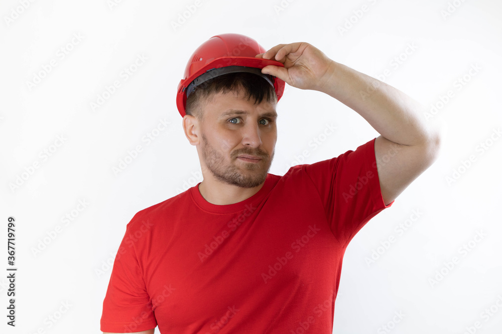 Construction worker in red construction helmet. Builder with a guilty face. Construction worker in red construction helmet. Builder with a guilty face.