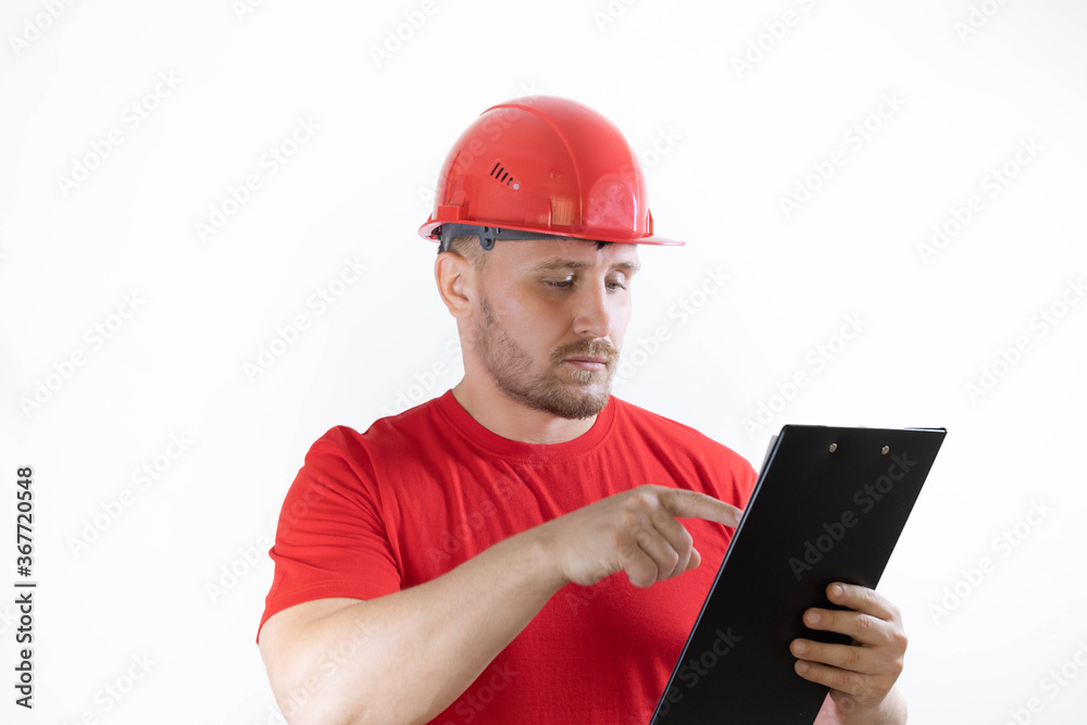 A man in a construction helmet and a red T-shirt. A man in a construction helmet and a red T-shirt.