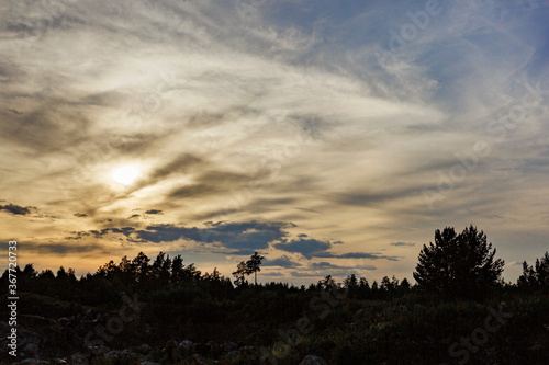 Natural Sunset Sunrise Over Field Or Meadow. Bright Dramatic Sky And Dark Ground. Countryside Landscape Under Scenic Colorful Sky At Sunset Dawn Sunrise. Sun Over Skyline, Horizon. Warm Colours.