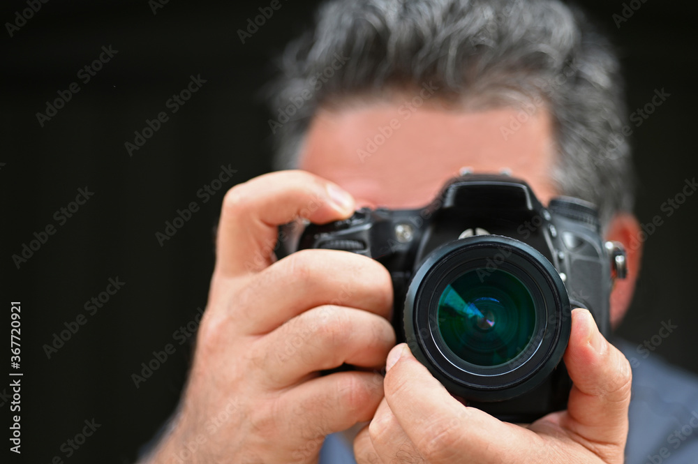 Man photographer photographing with a camera Man photographer photographing with a camera