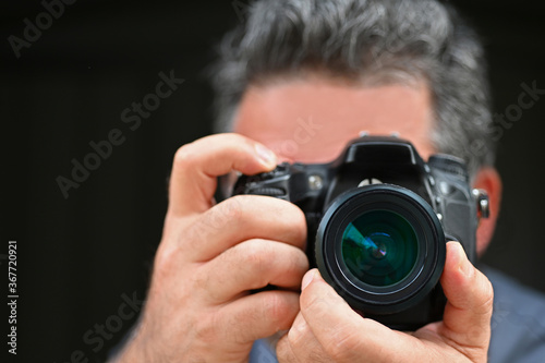 Man photographer photographing with a camera © Rafael Ben-Ari