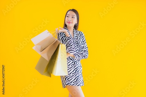 Portrait beautiful young asian woman with shopping bag from retail and department store