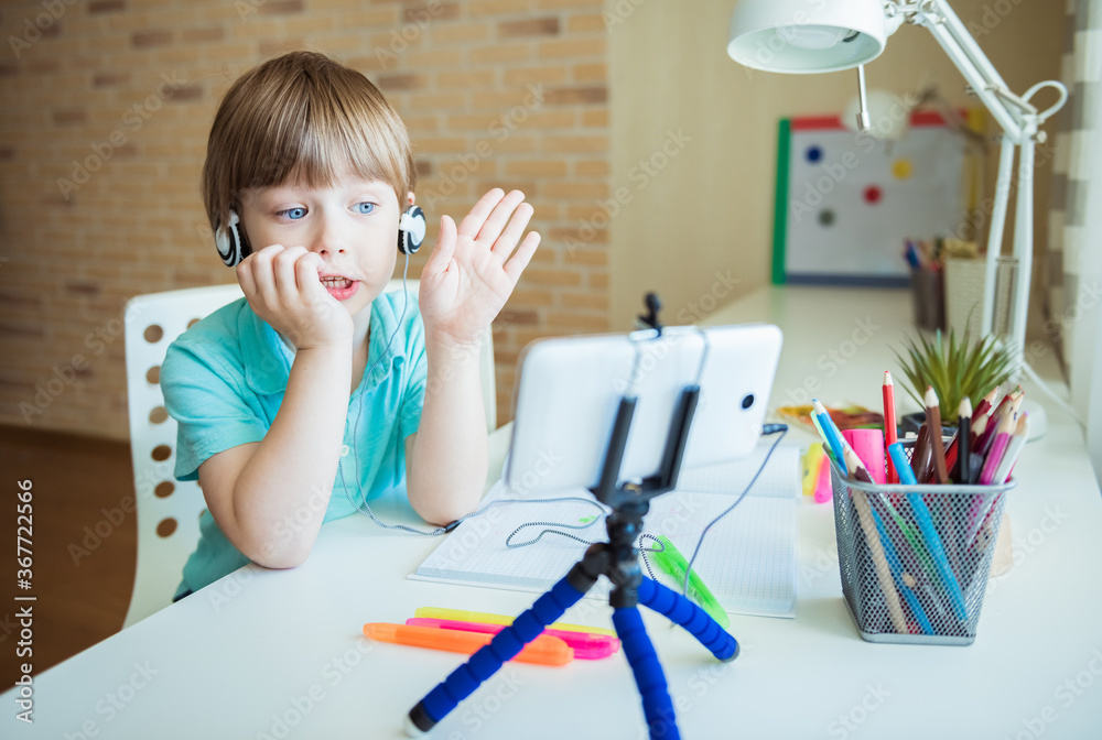 Cute little boy painting with color pencils at home, in kindergaten or preschool. Creative games for kids staying at home Cute little boy painting with color pencils at home, in kindergaten or preschool. Creative games for kids staying at home