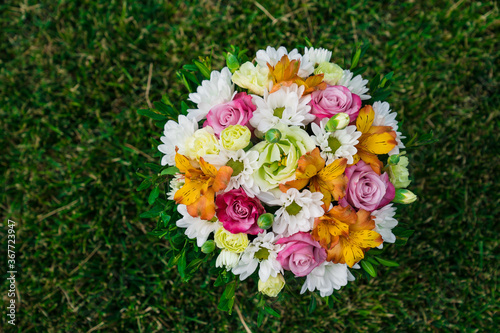 bouquet of colorful flowers on green lawn. place for text.