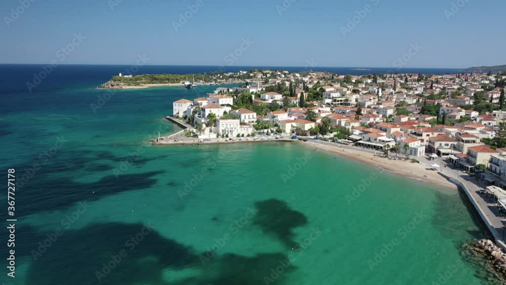 Aerial drone bird's eye view video of picturesque neoclassic houses in historic and traditional island of Spetses with emerald clear waters, Saronic Gulf, Greece Aerial drone bird's eye view video of picturesque neoclassic houses in historic and traditional island of Spetses with emerald clear waters, Saronic Gulf, Greece