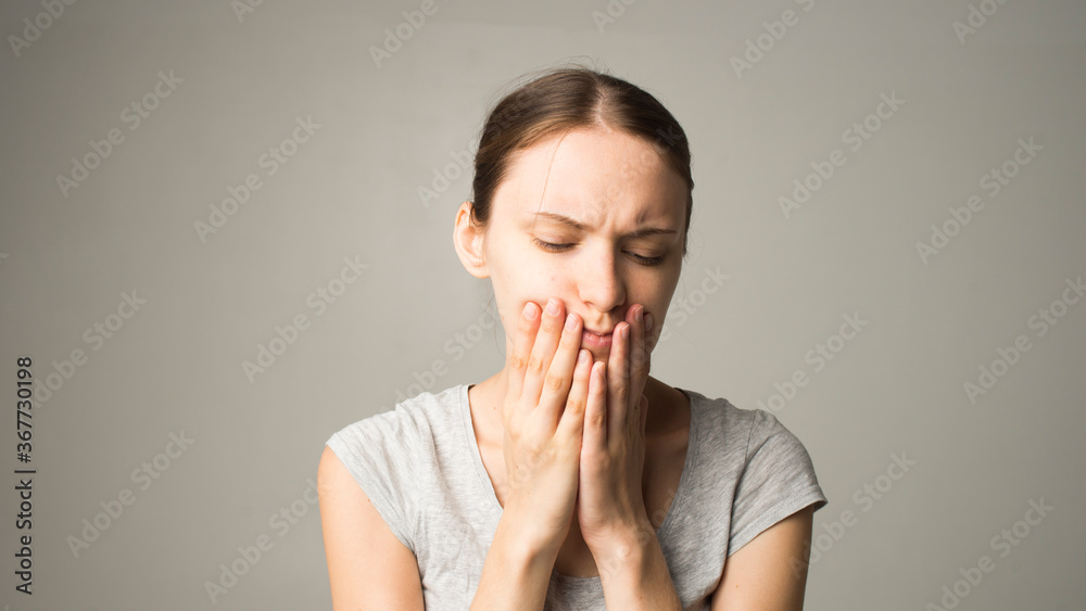 A tired woman feels pain in her teeth A tired woman feels pain in her teeth