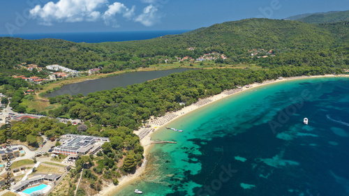 Aerial drone photo of beautiful popular organised sandy bay, turquoise beach and natural preserve lake with pine trees of Koukounaries, Skiathos island, Sporades, Greece © aerial-drone