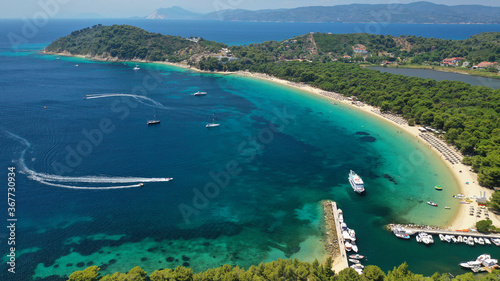 Aerial drone photo of beautiful popular organised sandy bay, turquoise beach and natural preserve lake with pine trees of Koukounaries, Skiathos island, Sporades, Greece photo