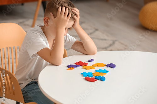Sad little boy with autisti...