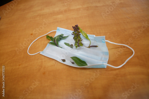 Face medical mask with Basil flower. memories of a dead people due to coronavirus