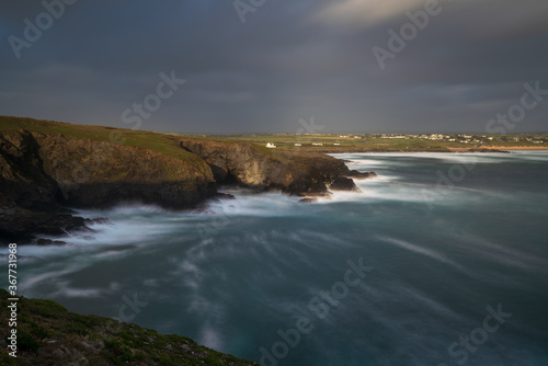 Trevose Head, Cornwall, UK. Long exposure of coastline and houses above cliff.