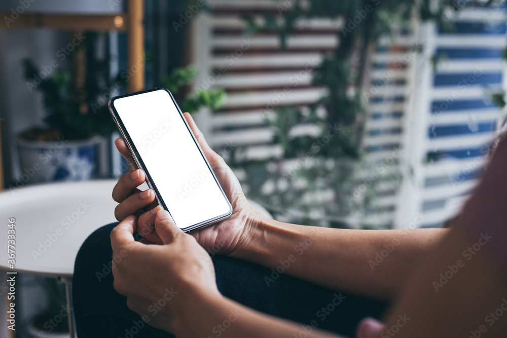 cell phone mockup image blank white screen.woman hand holding texting using mobile on desk at coffee shop.background empty space for advertise.work people contact marketing business,technology