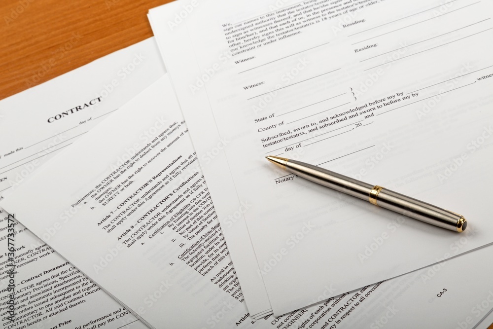 Pen on top of a contract Pen on top of a contract