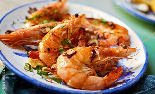 Grilled spicy pink prawns with fresh herbs photo