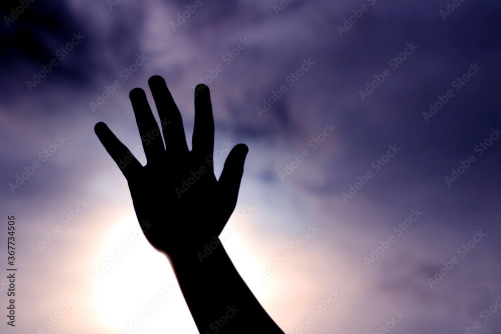 hand reaching out to the sky