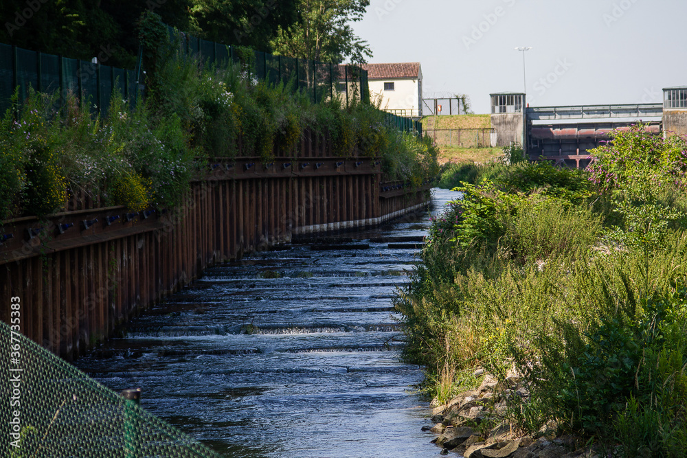 Fototapeta premium Here a fish ladder aid next to a hydroelectric power station. This allows fish to migrate upstream.