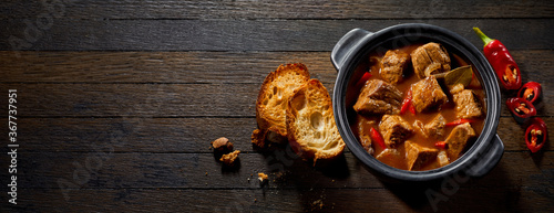 Pot if tasty German ragout with toasted baguette