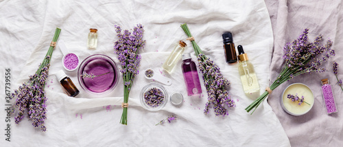 Lavender oils serum lavender flowers on white. Skincare cosmetics products. Set natural spa beauty products. Lavender essential oil, serum, body butter, massage oil, liquid. Flat lay long web banner