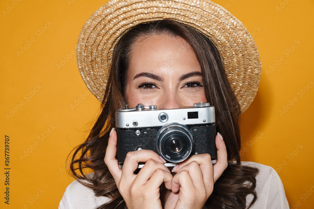 Image of cheerful nice woman using retro camera and smiling Image of cheerful nice woman using retro camera and smiling