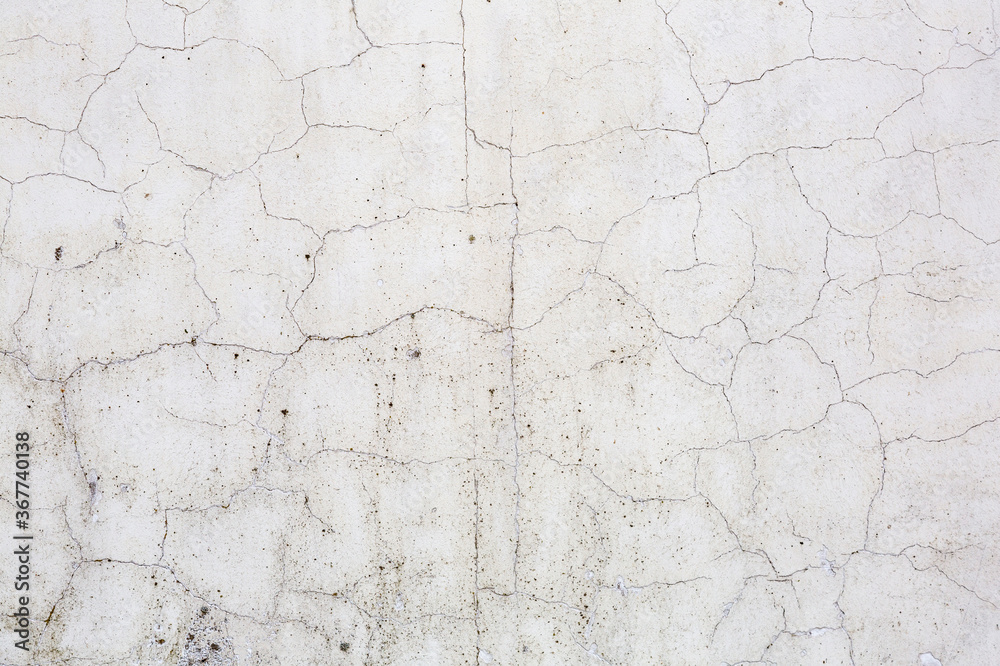 Textured surface of old stone weathered wall in the backyard Textured surface of old stone weathered wall in the backyard