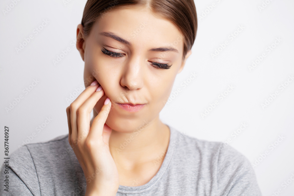 Portrait of a pretty young woman having a severe toothache Portrait of a pretty young woman having a severe toothache