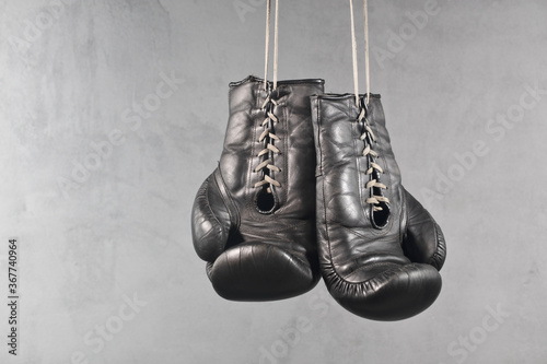 Beautiful older used boxings gloves on a gray cracked wall #S2101