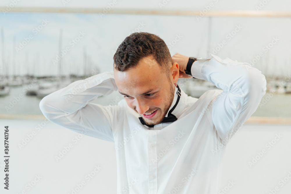 Portraits of the groom at the hotel training camp, dressed as a businessman in a black suit, tuxedo and white shirt Portraits of the groom at the hotel training camp, dressed as a businessman in a black suit, tuxedo and white shirt