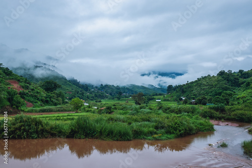 The river with beautiful foggy mountains and nature view in countryside
