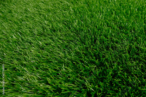 green artificial grass top view. floor covering. background, copy space