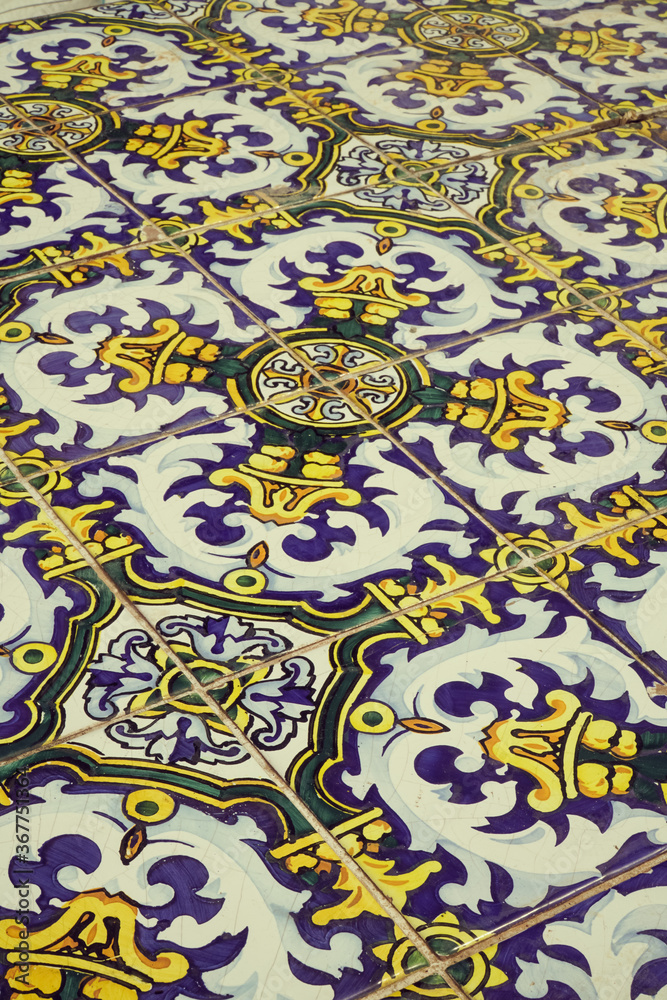 Traditional old arab tiles colored in yellow and blue.Close up shot