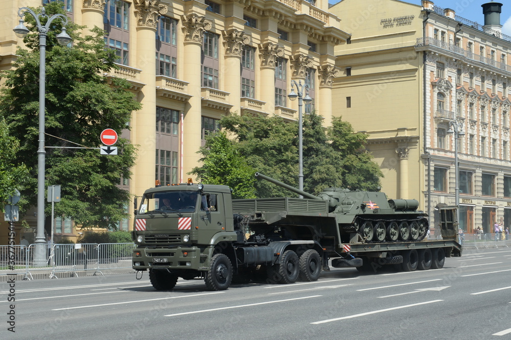  KamAZ-65225 truck tractor with a Soviet self-propelled artillery unit SU-100 drives after the parade dedicated to the 75th anniversary of Victory