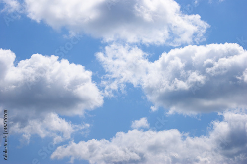 Light blue sky background with clouds.