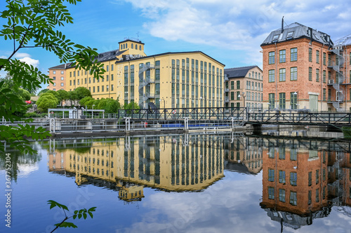 The old industrial landscape and Motala river during summer. Norrkoping is a historic industrial town in Sweden famous for its textile mills which closed long ago. photo