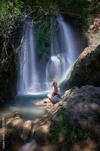 Photograph of a woman in the "Baño Chico" waterfall in Durcal, Granada.