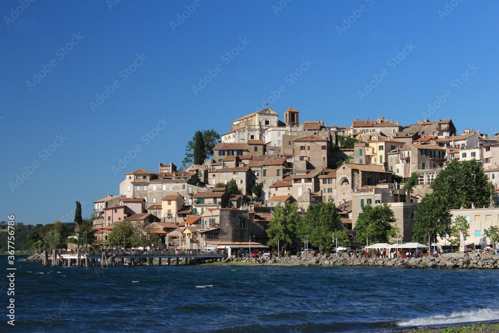 View of Anguillara Sabazia historic center and medieval Village,It nestles on a small cape on the coast of Lake Bracciano; its medieval center and its beach make it a popular destination for tourists.
