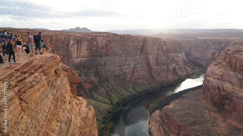 Horseshoe Bend rock formation with steep cliffs rising up from Colorado River in Page, Arizona, USA.
