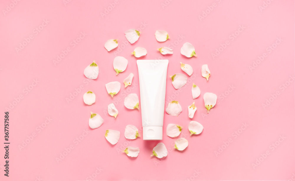 Delicate skin care cosmetic feminine flatlay. Top view Creative composition of face cream ,glass bottles and jars with cosmetic and flowers leaves Delicate skin care cosmetic feminine flatlay. Top view Creative composition of face cream ,glass bottles and jars with cosmetic and flowers leaves