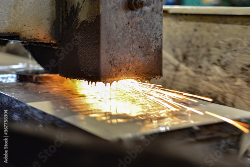 Grinding on a surface grinder. The part is mounted on a magnetic plate, a diamond-coated abrasive wheel is used for roughing.