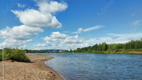 Fototapeta Naklejka Na Ścianę i Meble -  blue sky with clouds over the river on a sunny day