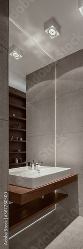 Trendy bathroom with concrete tiles  vertical panorama