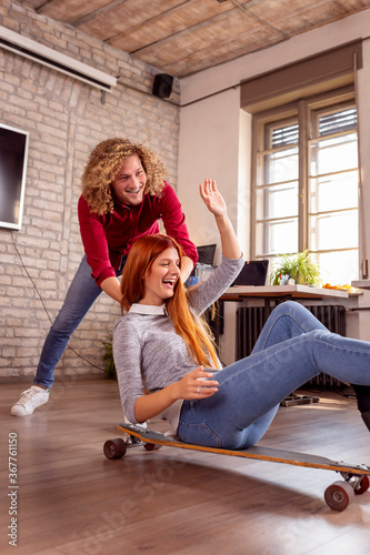 Freelancers riding a scate board at the office photo