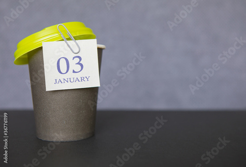 Coffee paper cup with calendar dates for January 03, Winter season. Time for relaxing breaks and vacations.